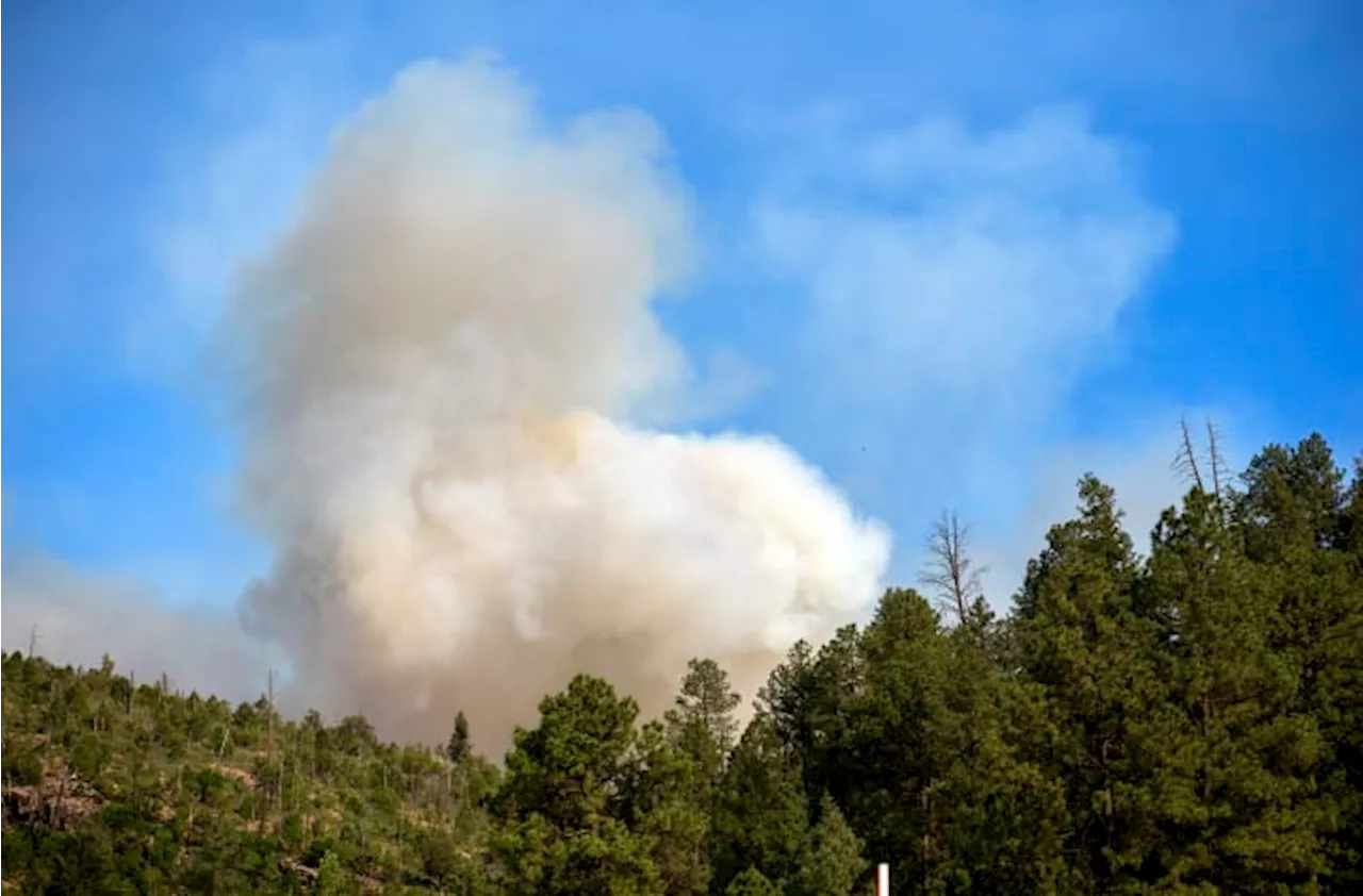 Cooler temps and rain could help corral blazes that forced thousands to flee New Mexico village