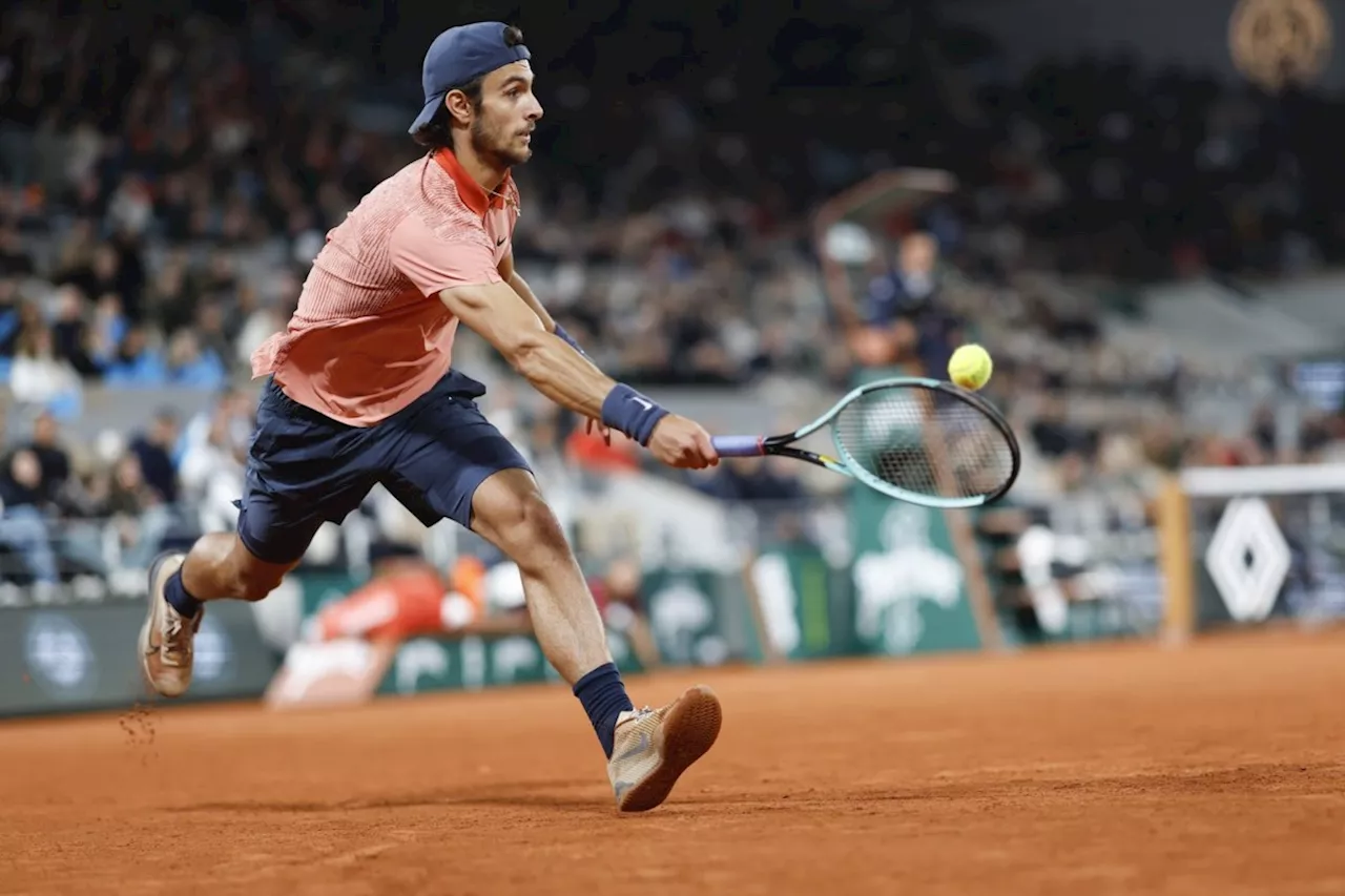 Novak Djokovic keeps his French Open title defense going by getting past Lorenzo Musetti in 5 sets