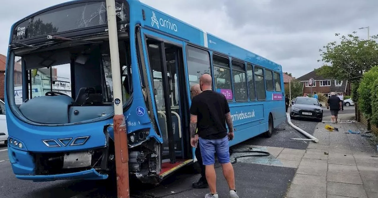 Bus careers onto pavement before smashing into car and lamp posts