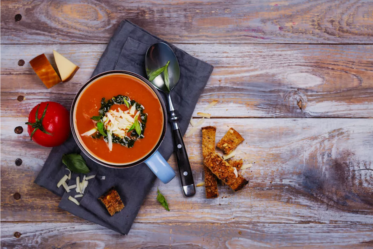 Tomato soup with pesto sauce and parmesan cheese