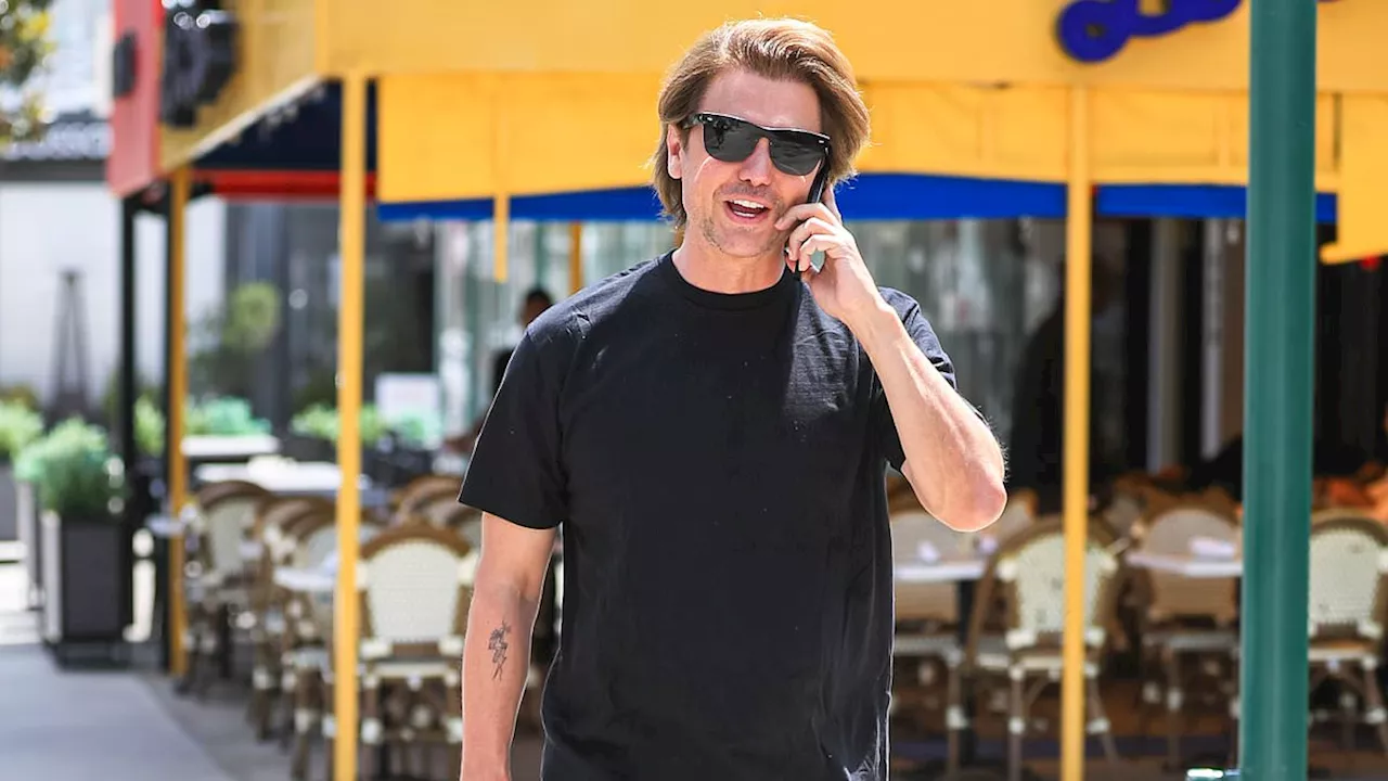 Jonathan Cheban flashes an arm tattoo as he chats on his cell phone in West Hollywood... after...