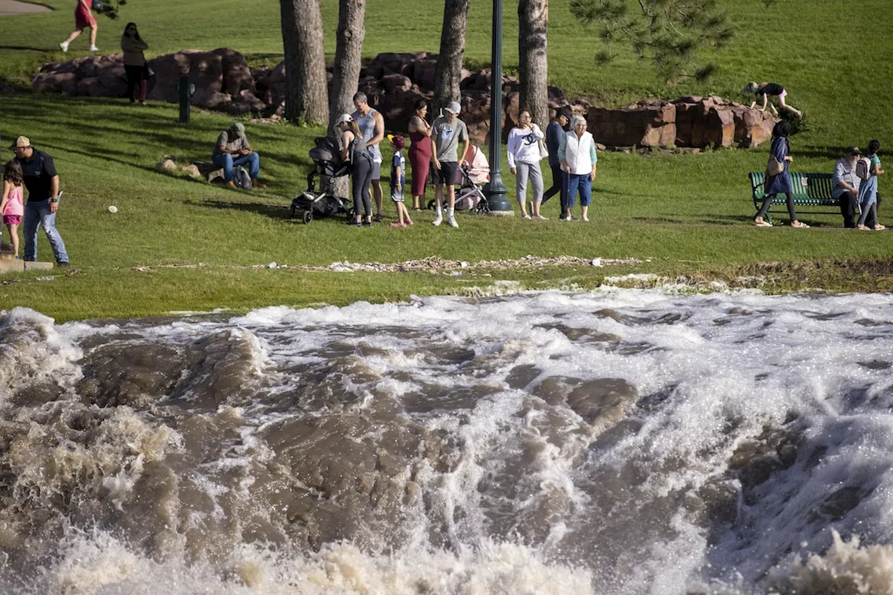 Millions in the U.S. prepare for more sweltering heat as floodwaters inundate parts of the Midwest