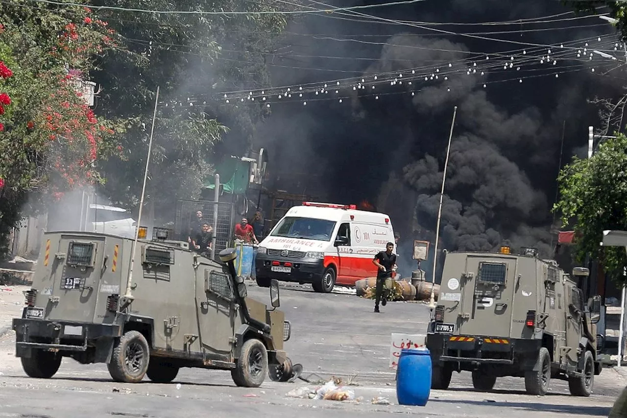 Israeli forces tie wounded Palestinian to jeep in West Bank raid