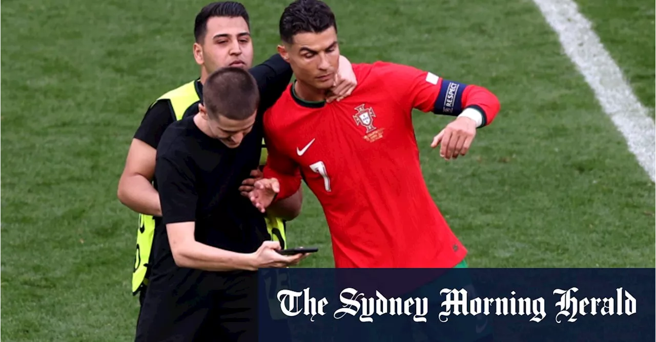 Fans seeking selfies with Ronaldo stop game six times as ‘slapstick’ own goal helps Portugal win