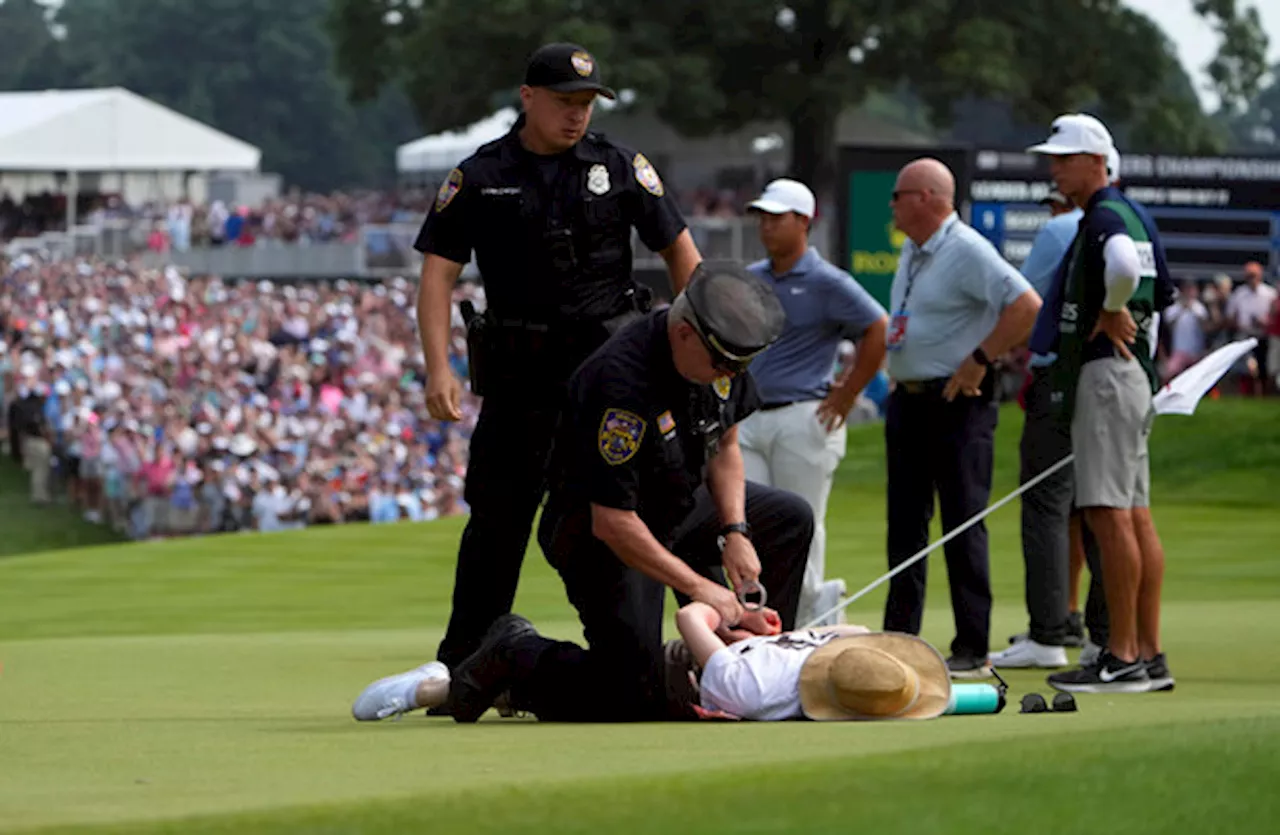 Scottie Scheffler wins Travelers play-off after protesters storm 18th green