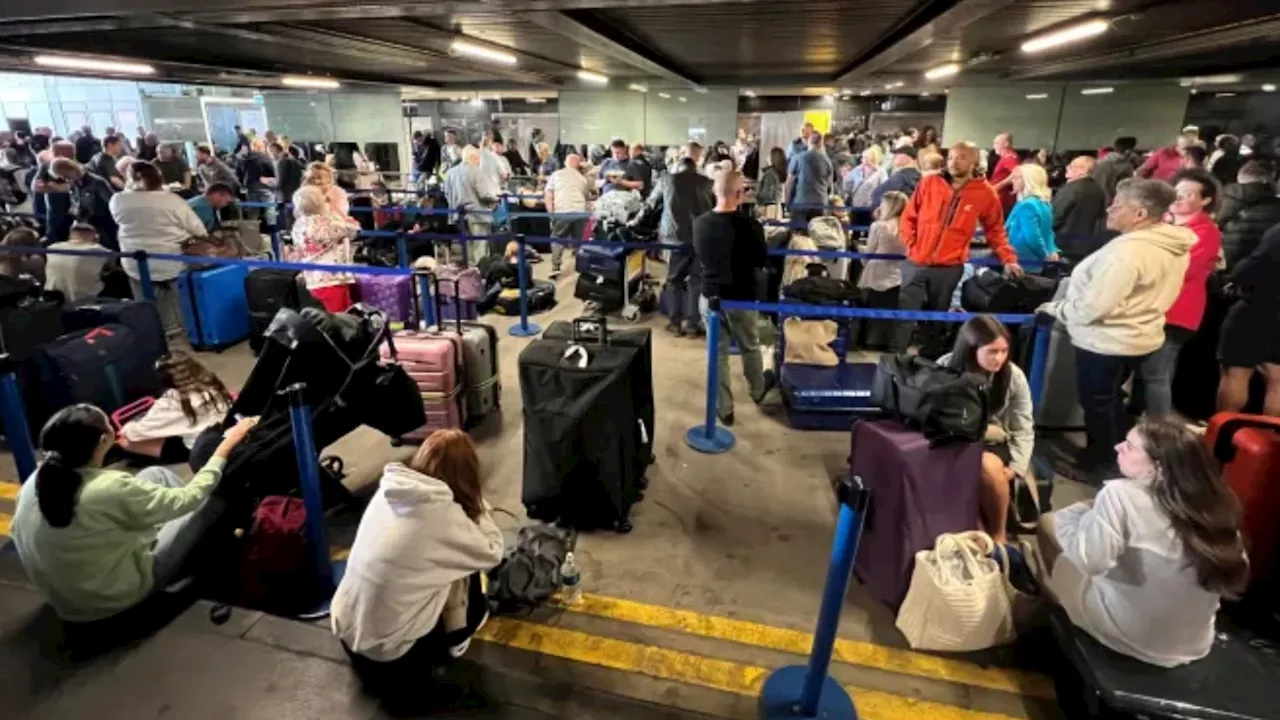 Furious passengers stuck on planes and in queues for HOURS with screaming kids in ‘utter chaos’ at Man...