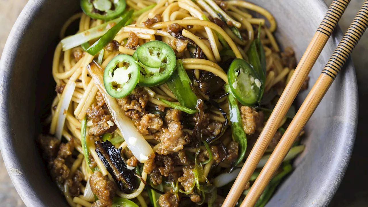 Thinly sliced fried scallions add bold flavor to savory pork noodles