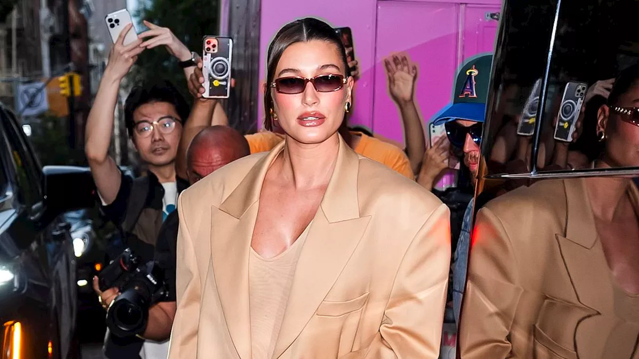 Pregnant Hailey Bieber shows off her baby bump in two sleek looks while husband Justin dresses...