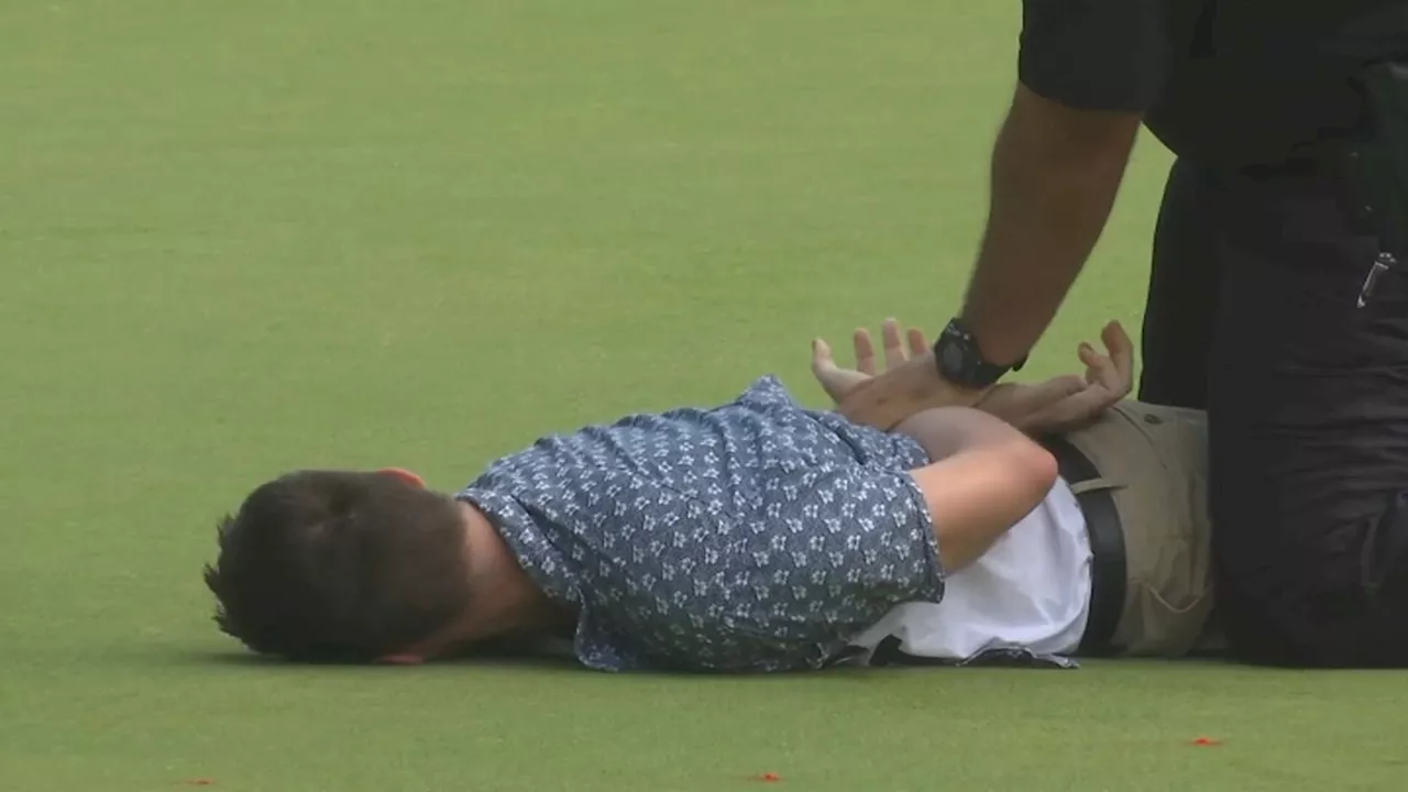 Protesters storm the 18th green at Travelers Championship