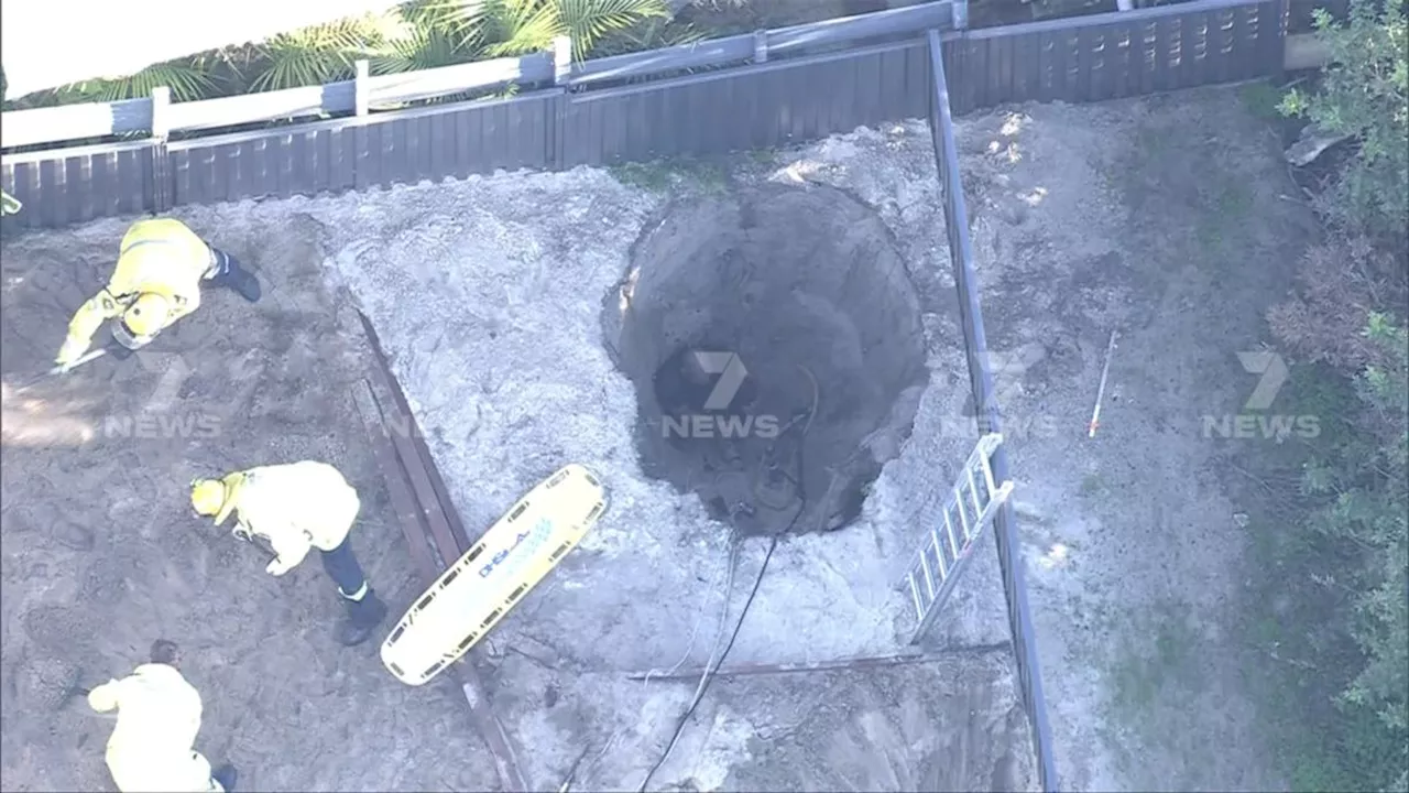 Emergency services work to rescue man from deep backyard hole in Hillarys, Perth