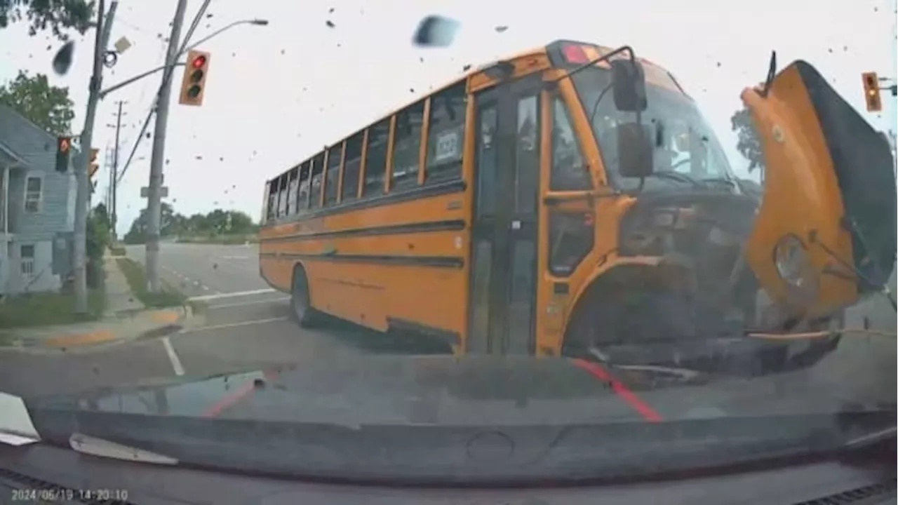 SUV driver's video appears to show school bus running a red light before collision