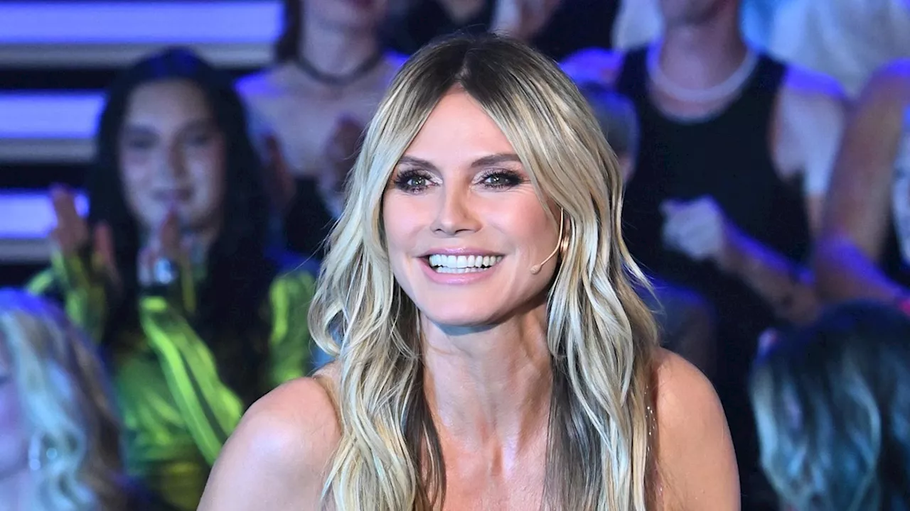 Heidi Klum strikes a pose in bronze metallic swimsuit highlighting her statuesque figure