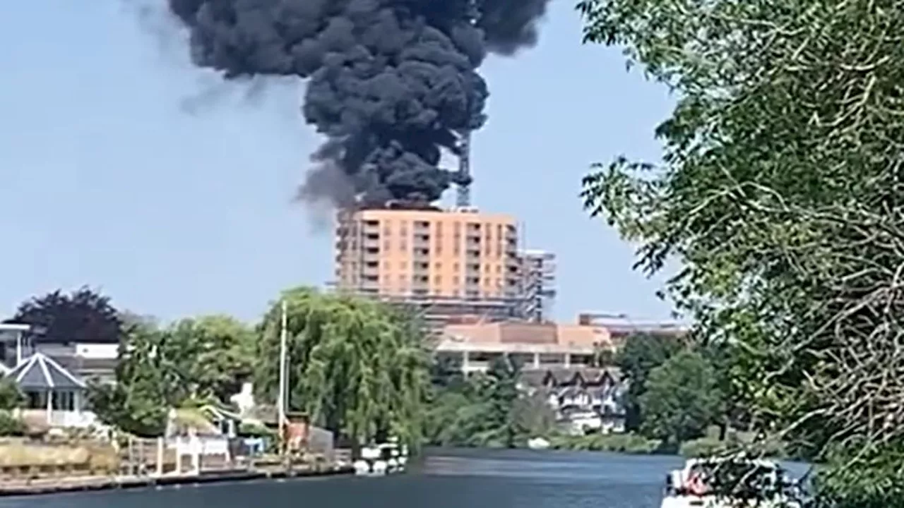 Huge fire breaks out on roof of Surrey block of flats