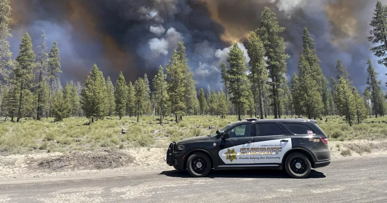 Wind-driven wildfire spreads outside a central Oregon community and prompts evacuations