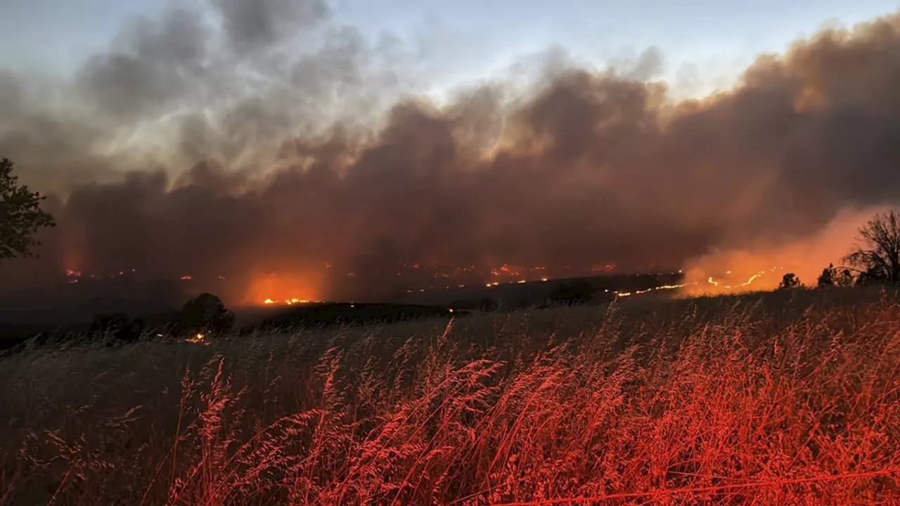 Gusty winds help spread fast growing central Oregon wildfire and prompt evacuations