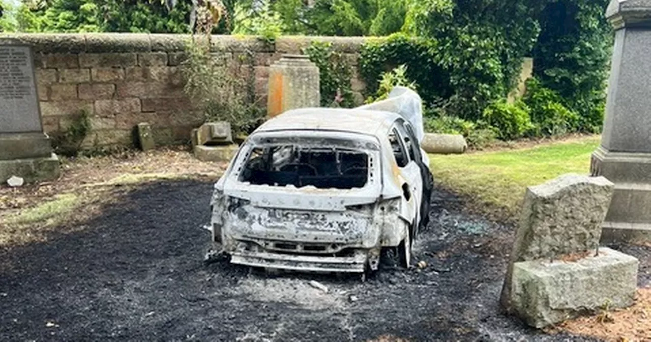 Police probe launched after car dumped and torched in Scots graveyard