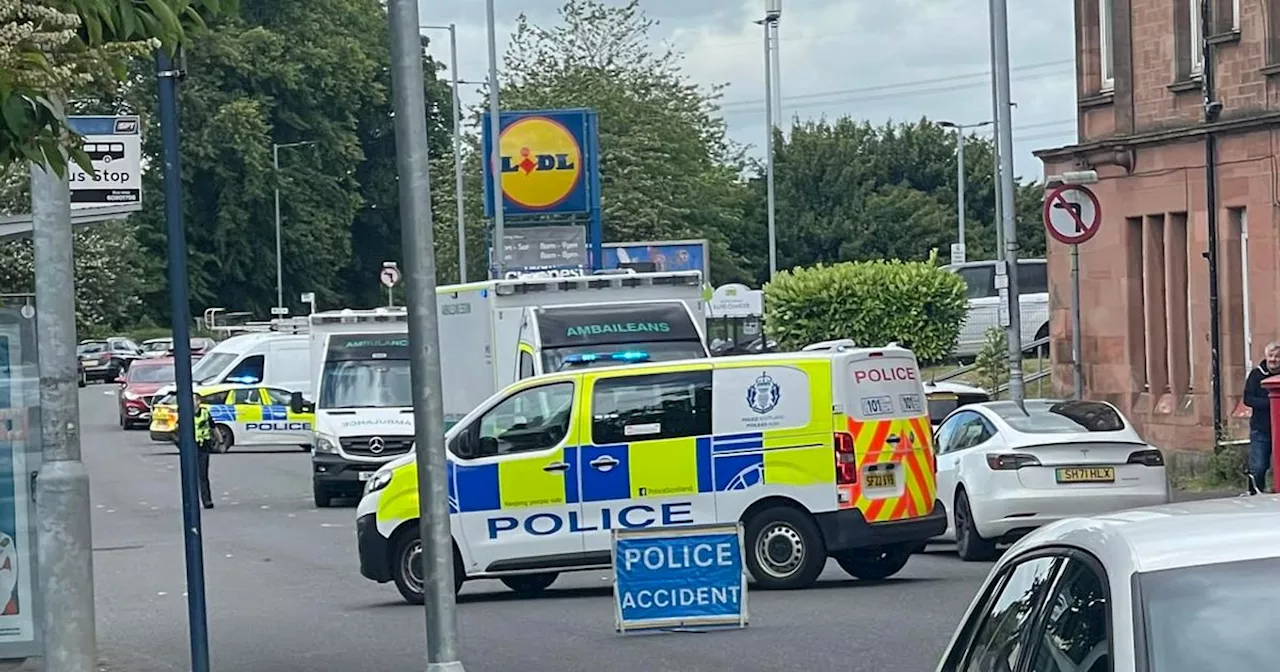 Car hits mobility scooter on Glasgow street as emergency services race to scene