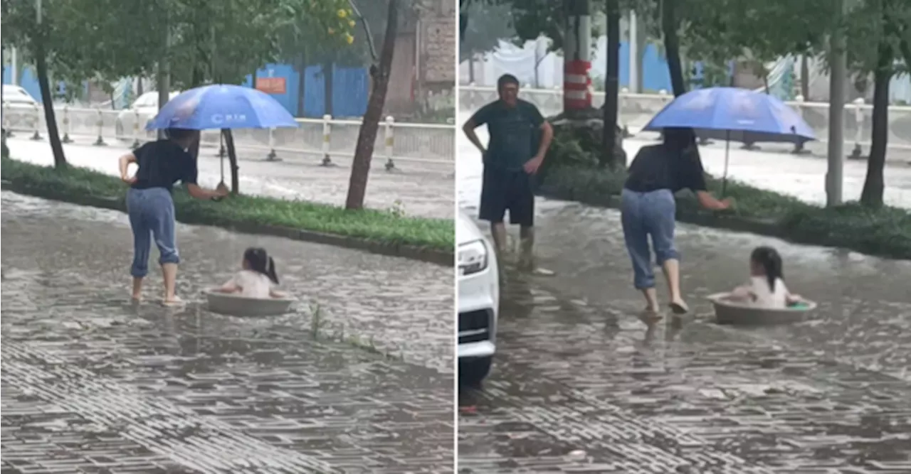 [VIDEO] Little Girl Drifting Down Flooded Road In Makeshift Boat Is The Cutest Thing Ever