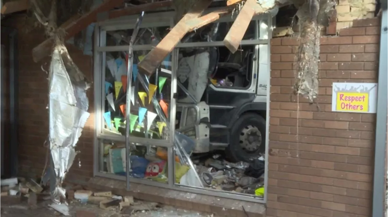 Truck ploughs through intersection, hitting multiple cars, before crashing into school in Moorebank