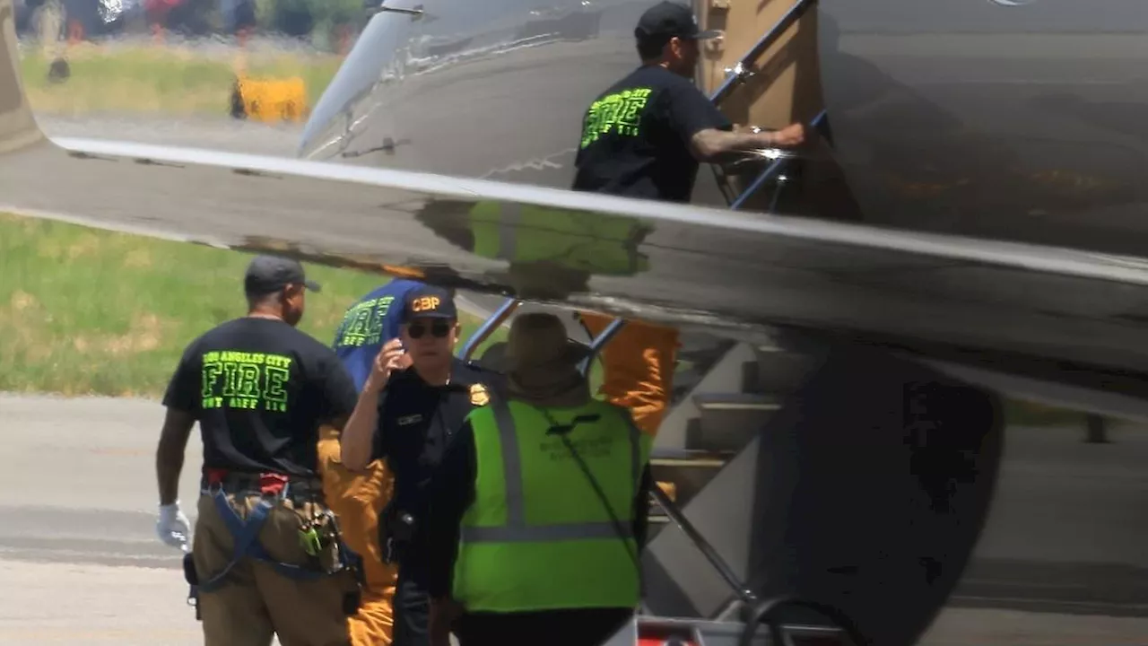 Kim Kardashian's private jet is visited by aircraft rescue firefighters as she touches down safely...