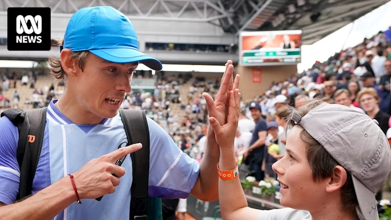 Alex de Minaur's young super fan joins him on court as the Australian makes waves at the French Open