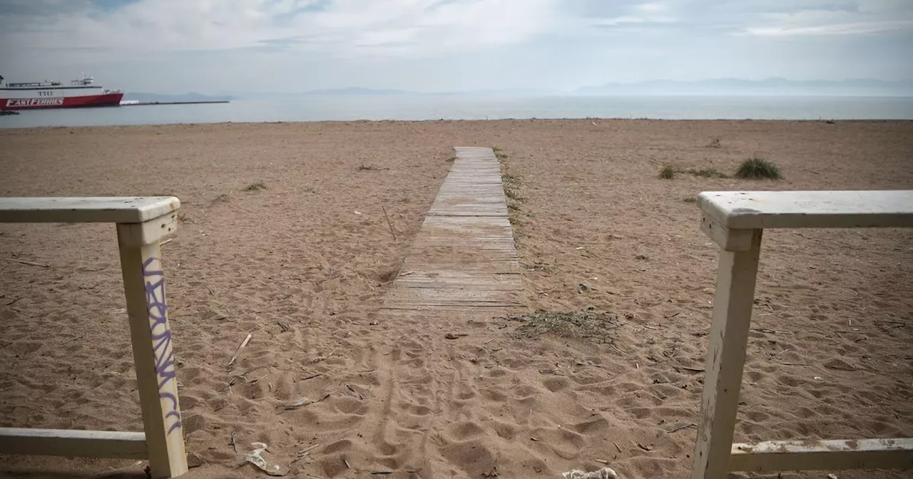 Man's body with barbell attached to leg found in waters off popular Greek beach