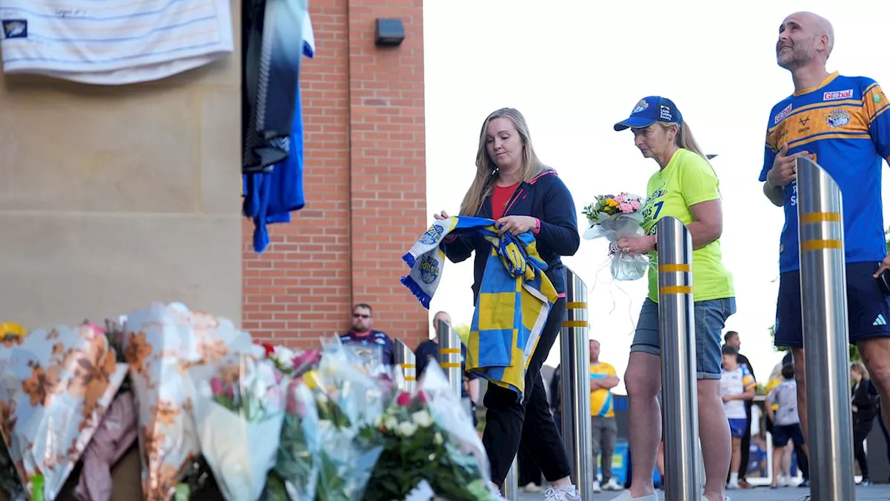 Grieving rugby league fans pay touching tributes to Rob Burrow as they lay shirts and flowers...