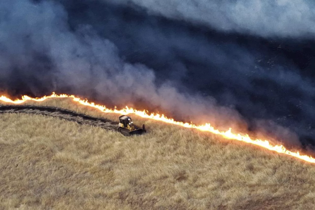 California firefighters continue battling wind-driven wildfire east of San Francisco