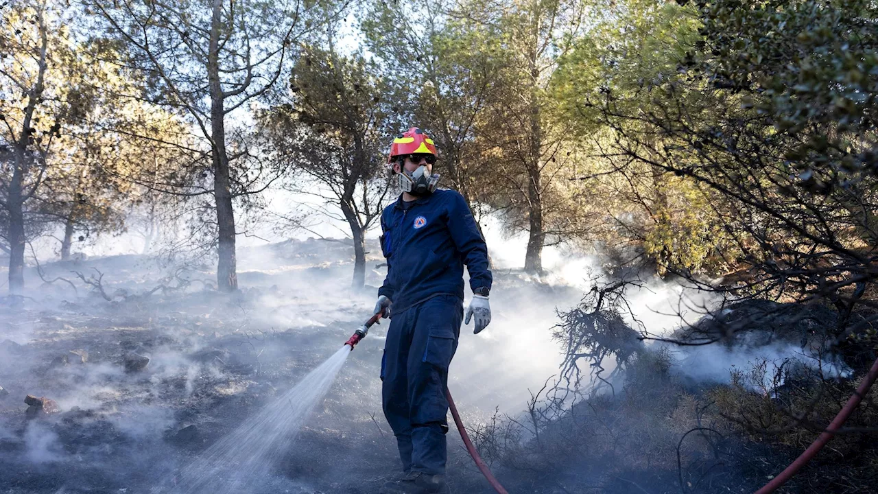 Two wildfires are burning near Greece's capital, fueled by strong winds