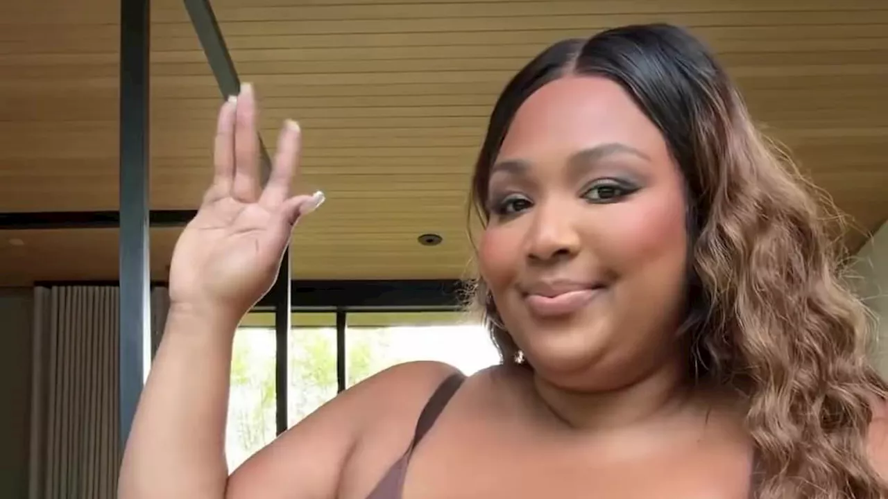 Lizzo showcases her curves as she opens up in a 'nearly naked talk' about vowing to replace negative...