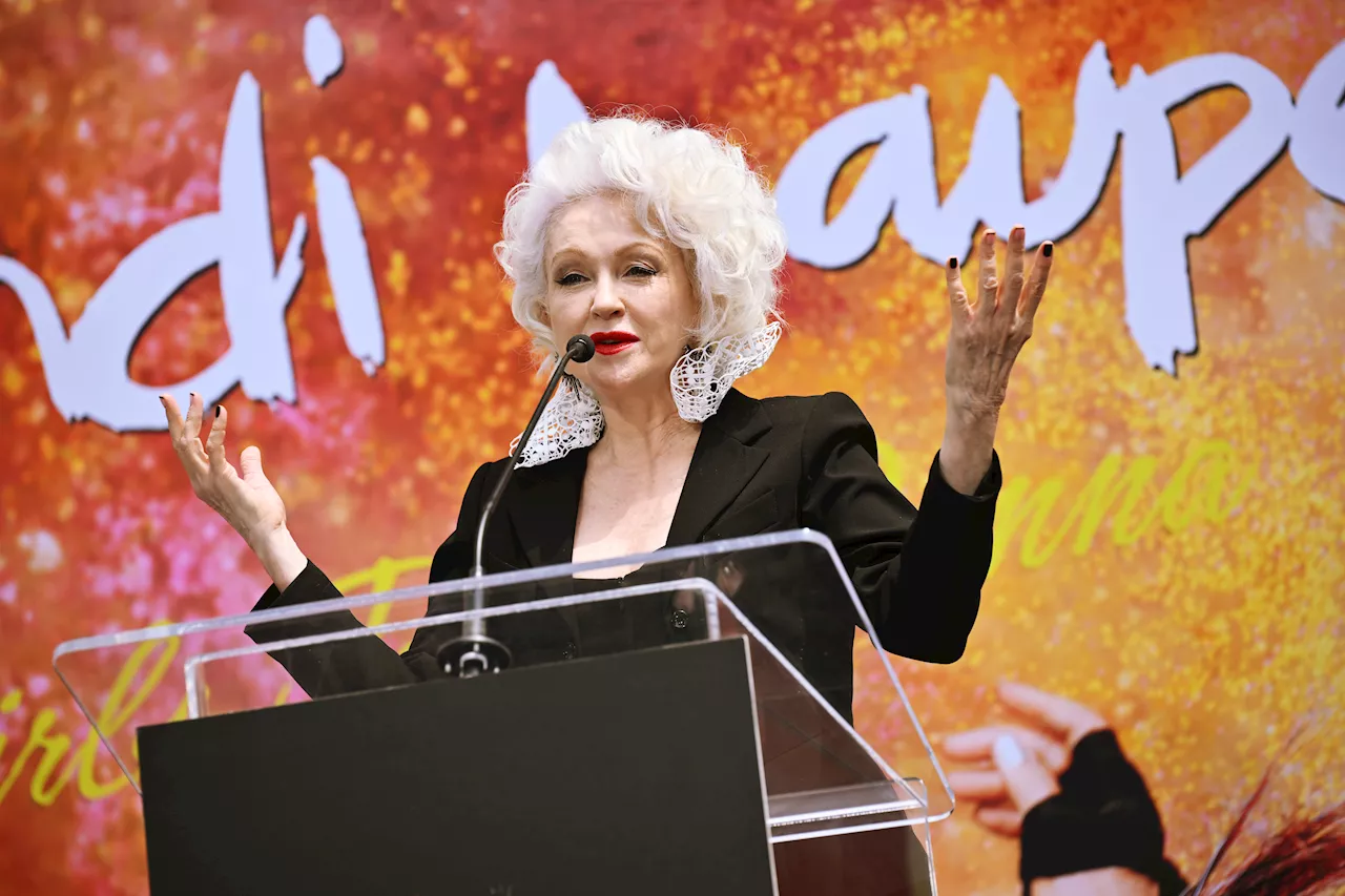 Cyndi Lauper has fun placing handprints, footprints outside TCL Chinese Theatre