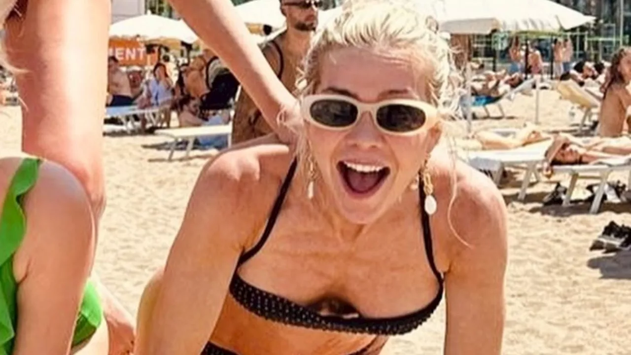 Kate Lawler reveals her ripped body as she strips down to bikini on wild hen do in Spain...