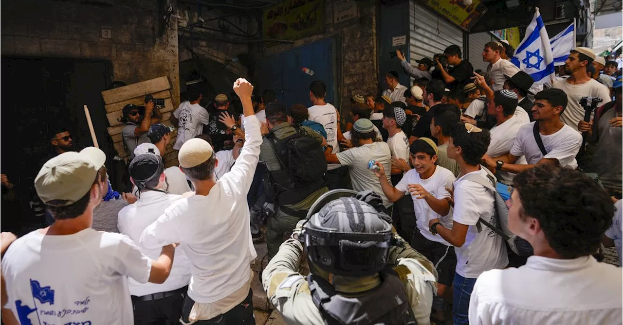 Israeli nationalists march through Palestinian area of Jerusalem, some chanting 'Death to Arabs'