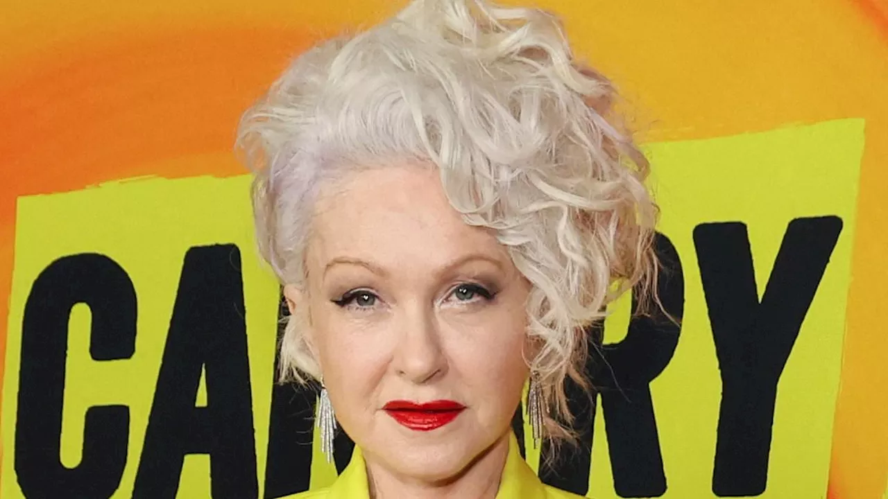 Cyndi Lauper, 70, is effortlessly radiant in a chic yellow suit as she attends star-studded LA...