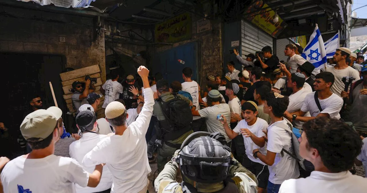 Israeli nationalists march through Palestinian area of Jerusalem, some chanting 'Death to Arabs'