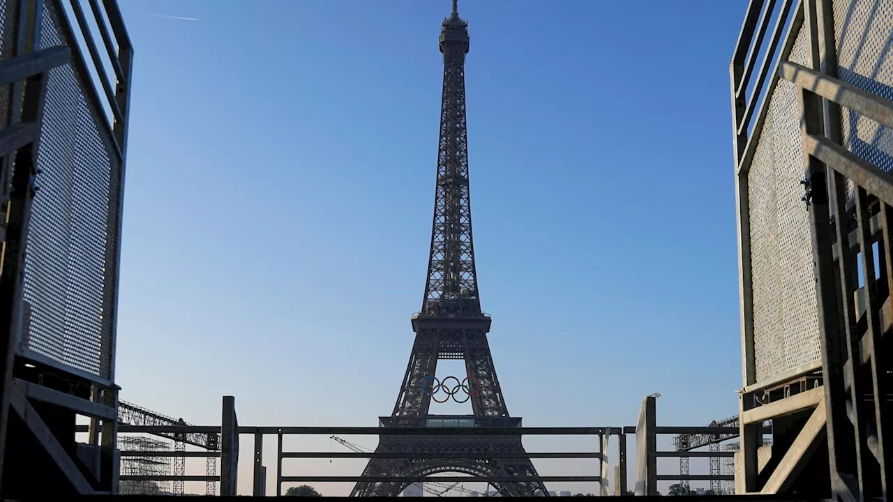 Paris Olympics organizers unveil a display of the five Olympic rings mounted on the Eiffel Tower