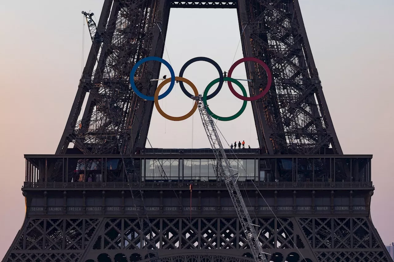Organizers unveil display of five Olympic rings mounted on Eiffel Tower