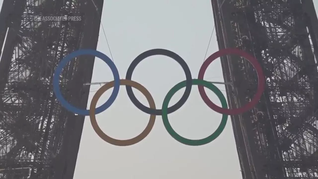 Paris Olympics organizers unveil a display of the five Olympic rings mounted on the Eiffel Tower