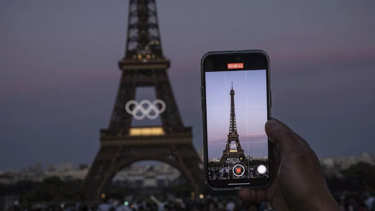 The Olympic rings are mounted on the Eiffel Tower to mark 50 days until the Paris Games