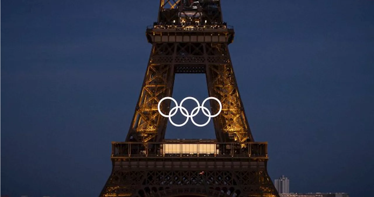 Olympic rings mounted to Eiffel Tower, marking 50 days until Paris games