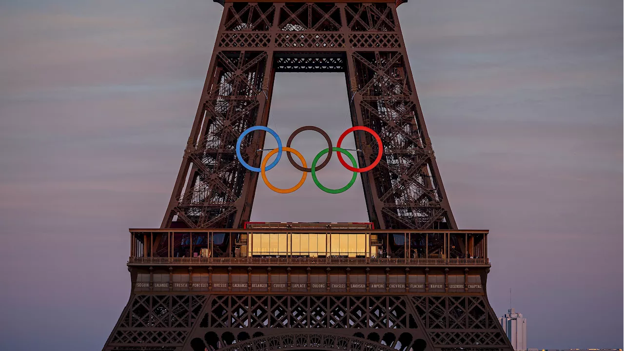 Paris Olympics organizers unveil a display of the five Olympic rings mounted on the Eiffel Tower