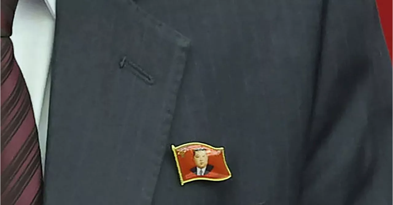 North Koreans are seen wearing Kim Jong Un pins for the first time as his personality cult grows