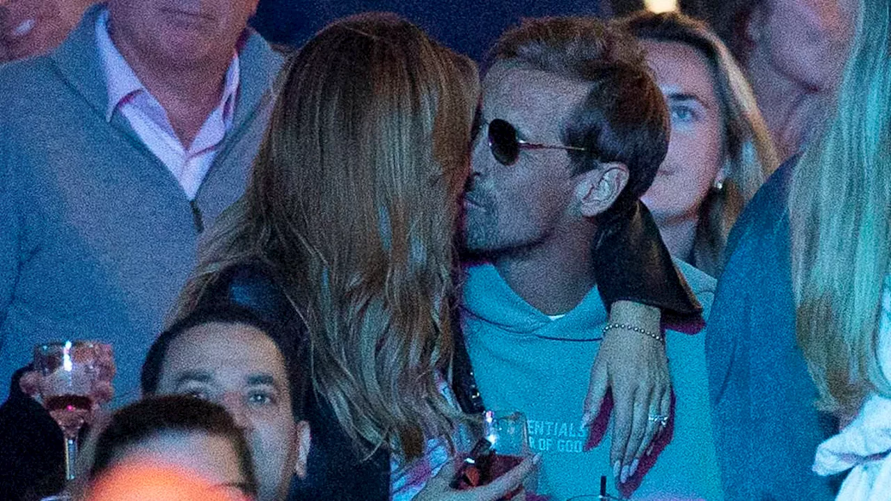 Abbey Clancy shares a passionate kiss with husband Peter Crouch as they enjoy a boozy day out at...