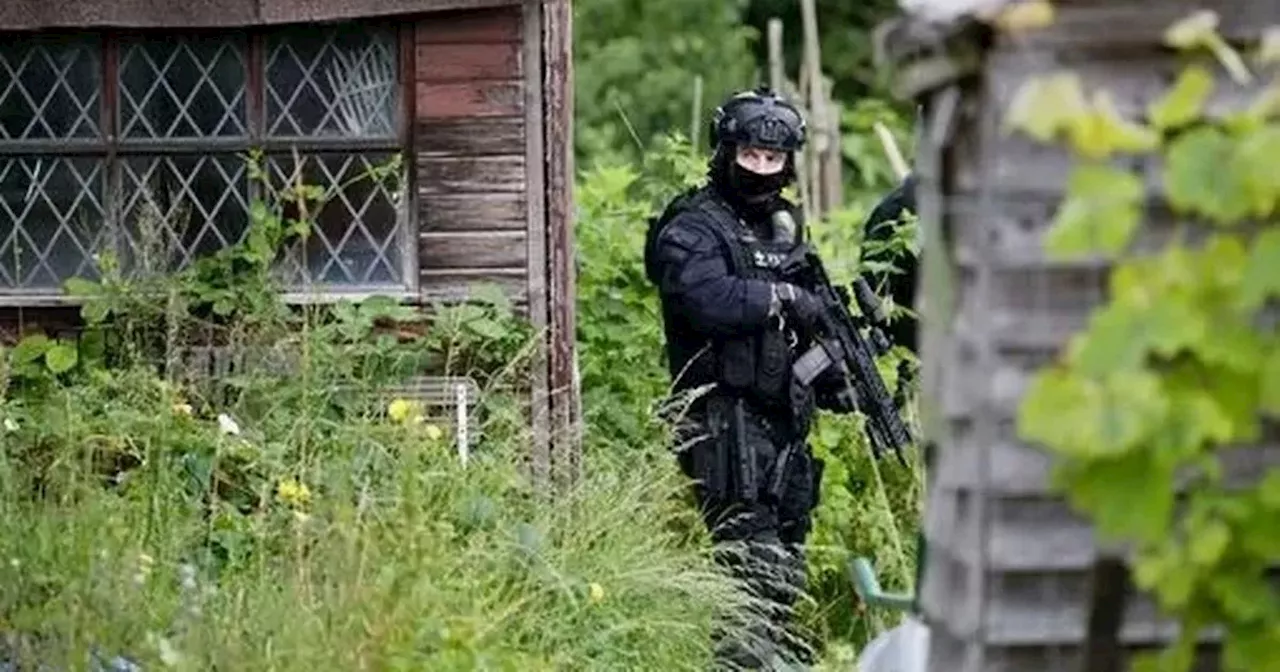 Crossbow murder hunt as armed police swarm cemetery