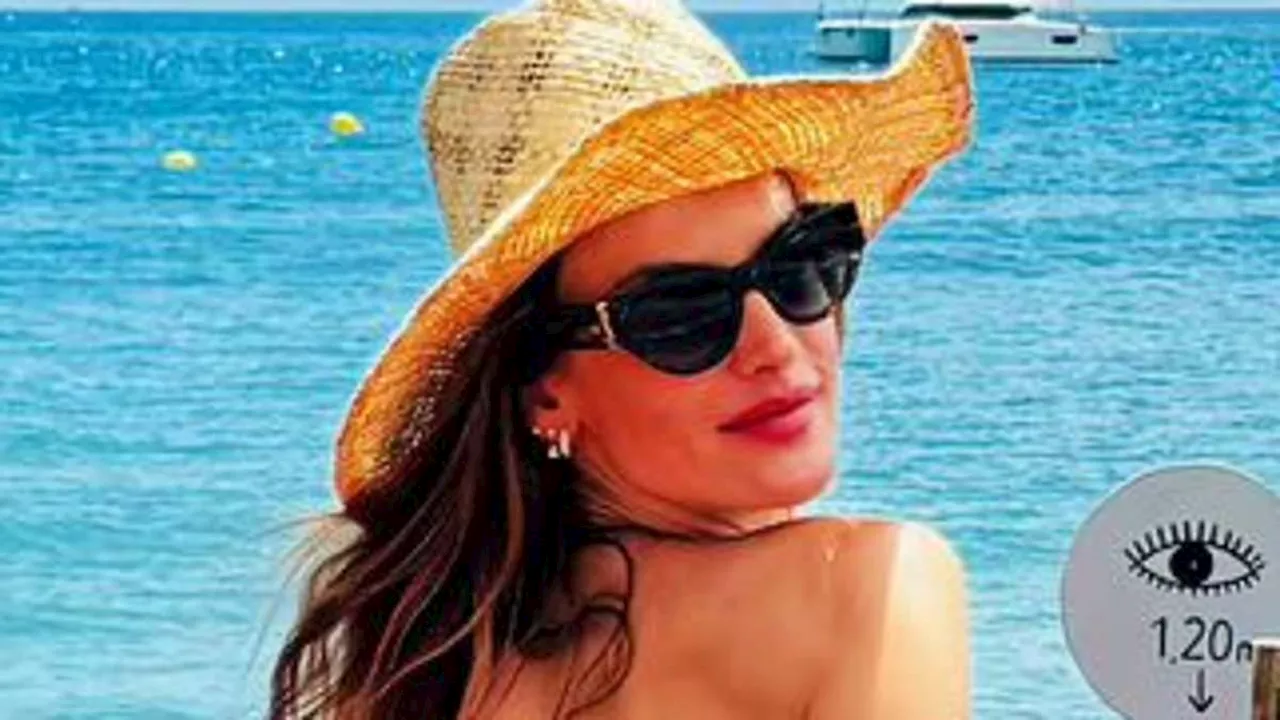 Alessandra Ambrosio, 43, puts on cheeky display in tiny red bikini as she soaks up the sun in Ibiza