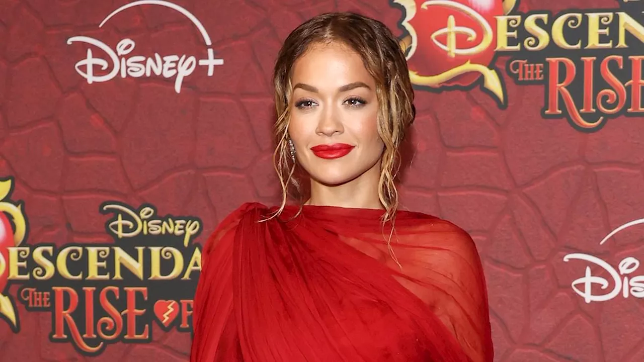 Rita Ora is red hot in fiery gown with a sizzling thigh-high slit as she leads the glamour...