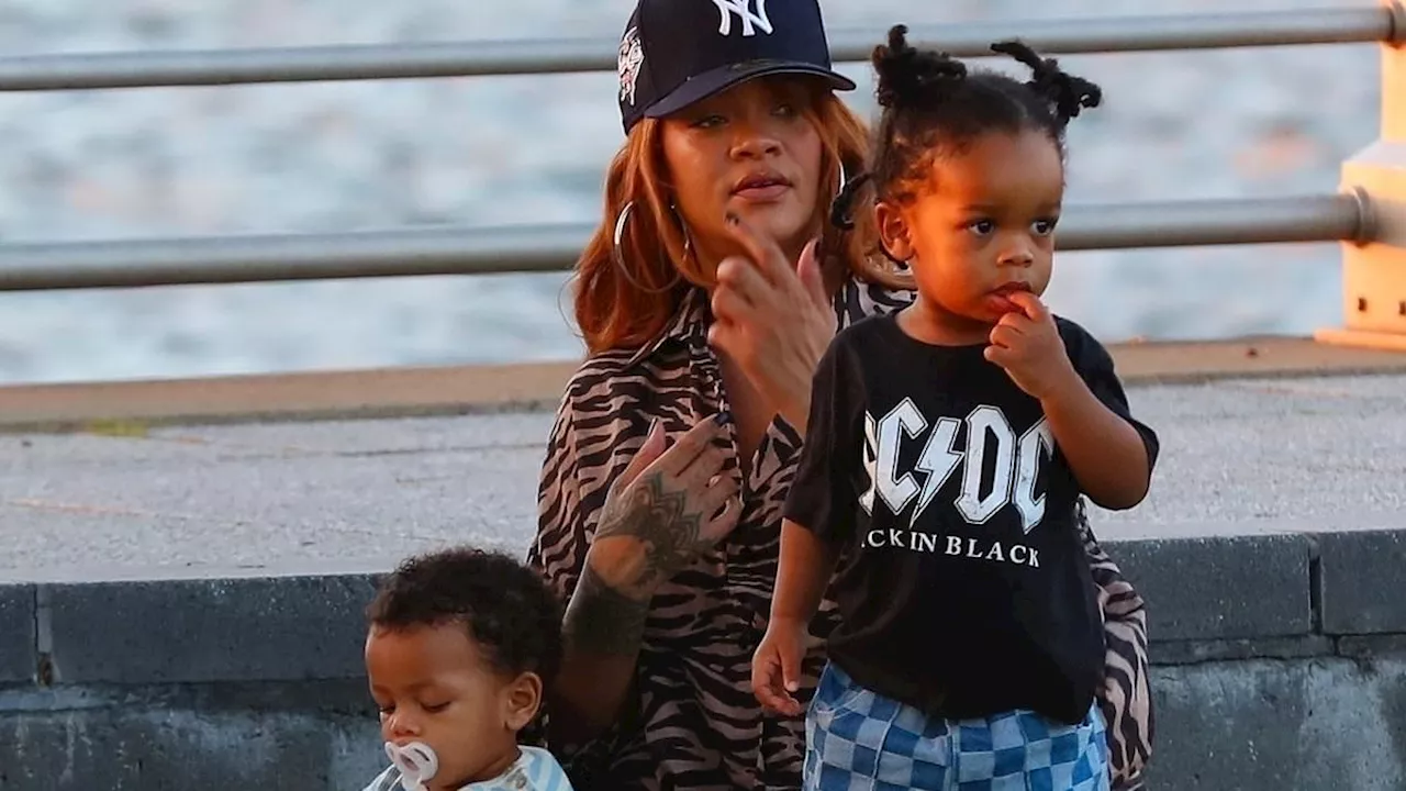 Rihanna lounges on blanket with sons RZA, 2, and Riot Rose, 11 months, during family picnic in the...