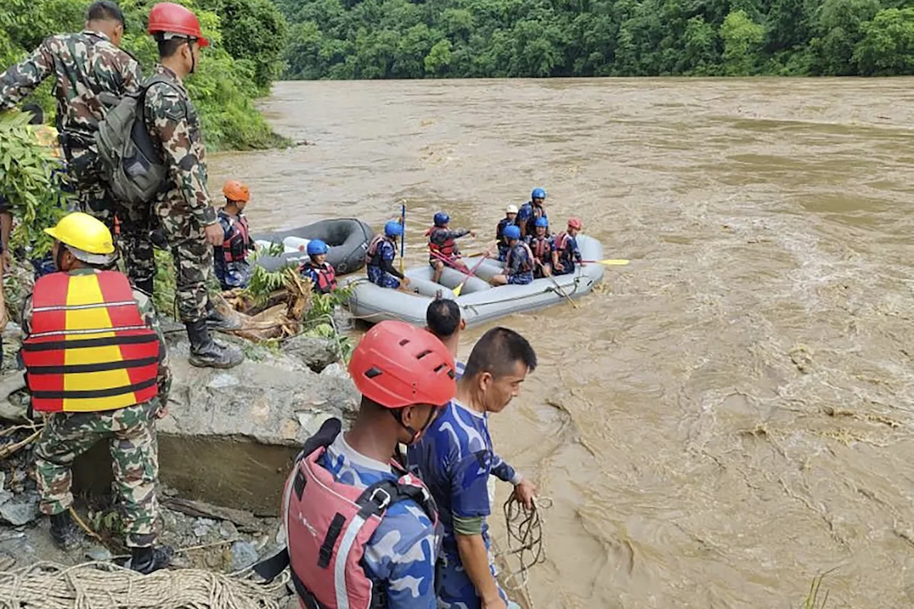 Two buses carrying at least 60 people swept into a river by a landslide in Nepal, three survivors found