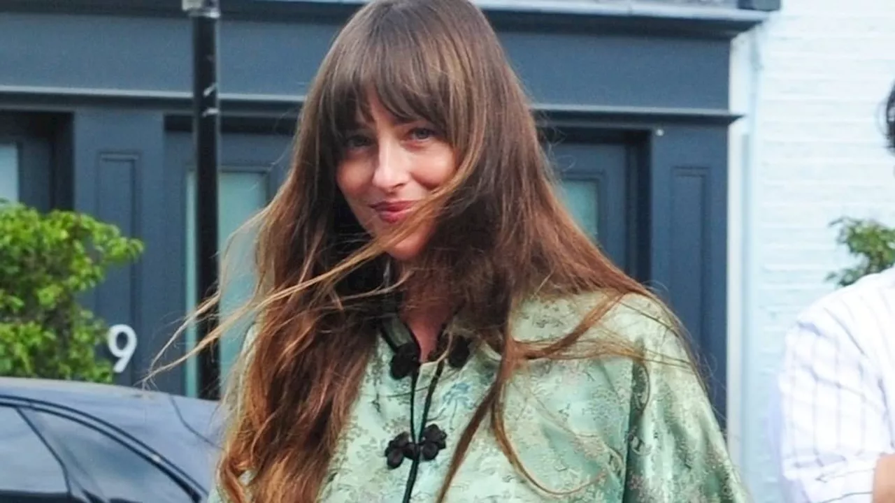 Dakota Johnson flaunts her summer style in a green kimono jacket leaving a London salon after...