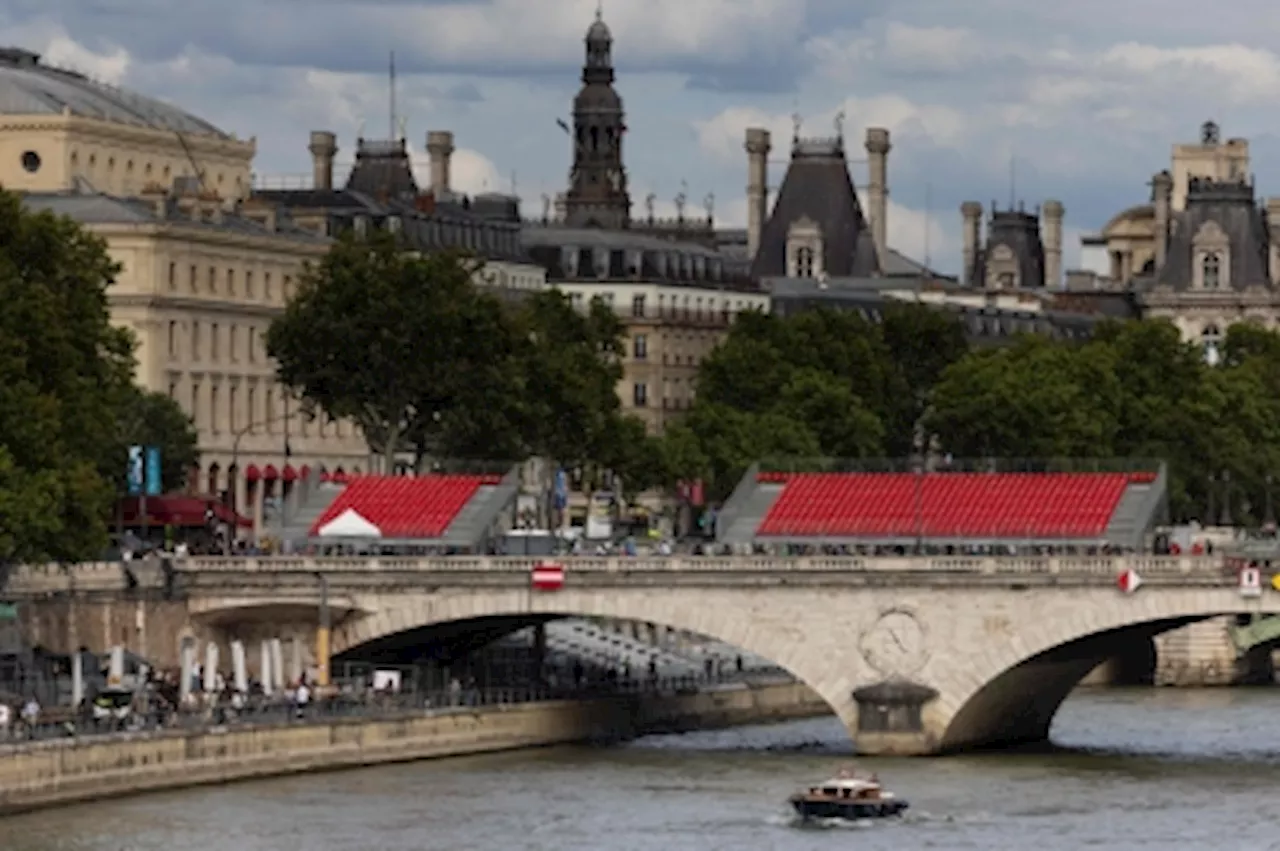 French sports minister swims in the Seine, raises hopes the river will be clean enough for the Olympics